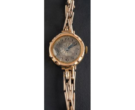 An early 20th century dress wristwatch, the silvered enamel dial with black Arabic numerals, the case stamped '375', with int