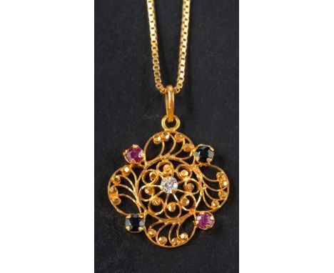 A quatrefoil, openwork ruby, sapphire and white paste pendant, stamped '875', length ca. 3.2cm, total weight ca. 3.6gms; toge