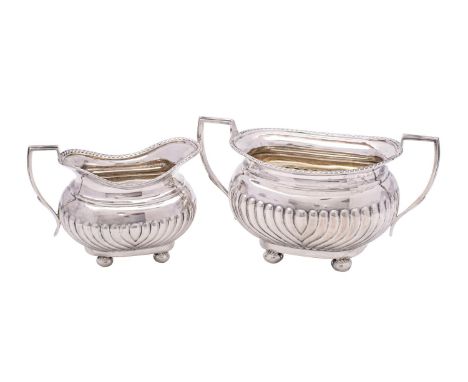 A late Victorian two-piece tea service, maker GAG, Sheffield, 1899 of barge-shaped outline with gadrooned borders and half re
