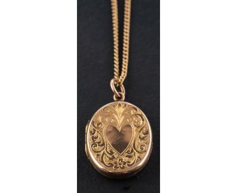 An oval locket pendant, with engraved with heart-shaped and foliate decoration, stamped '9CT', together with a curb-link chai