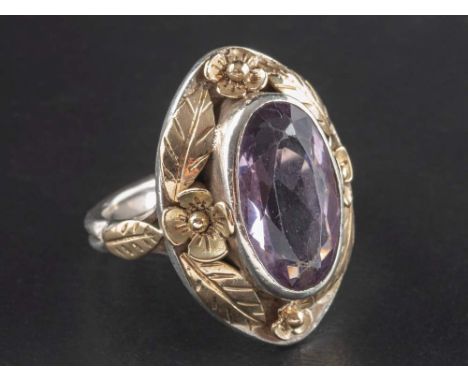 An Arts and Crafts style, amethyst single-stone ring, estimated amethyst weight ca. 4.85cts, with applied floral and foliate 