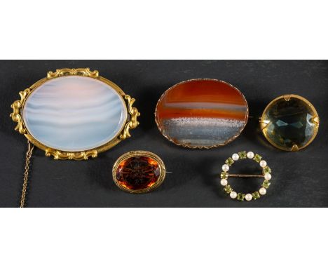 Five gemset brooches, including a 9ct gold, peridot and cultured pearl wreath brooch, with hallmarks for London, 1993; a carn