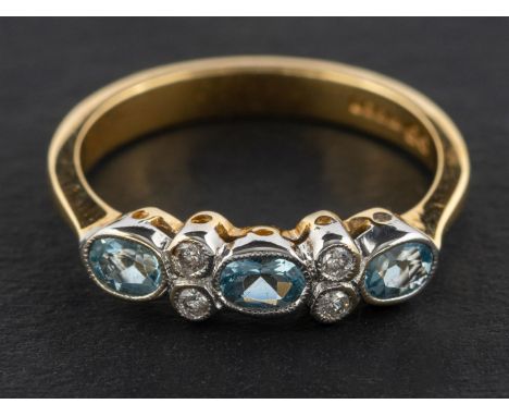 An 18ct gold, oval, mixed-cut aquamarine and round, brilliant-cut diamond ring, total estimated diamond weight ca. 0.08ct, to