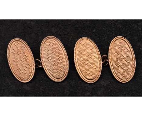 A pair of oval, cufflinks with engine-turned decoration, with hallmarks for Birmingham, 1927, length of cufflink head ca. 1.9