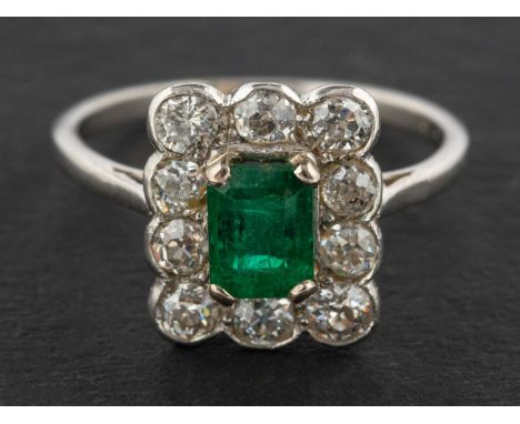 An emerald-cut emerald and old-cut diamond cluster ring, estimated emerald weight ca. 0.60ct, total estimated diamond weight 