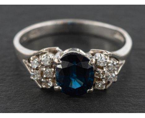 An 18ct gold, oval, mixed-cut sapphire and single-cut diamond ring, estimated sapphire weight ca. 1ct, with import marks for 