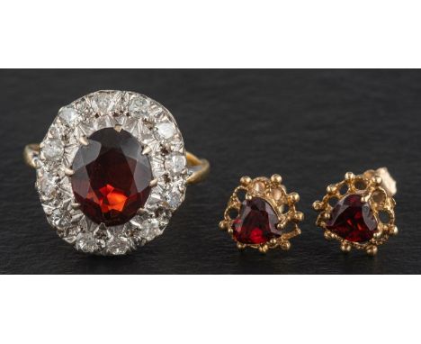 A garnet, single and round, brilliant-cut diamond cluster ring, total estimated diamond weight ca. 0.60ct, H-I colour, P1-2 c