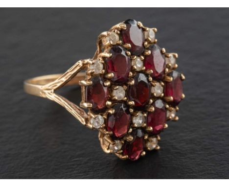 A 9ct gold, garnet and white paste cluster ring of chequerboard design, with hallmarks for London, 1975, length of ring head 