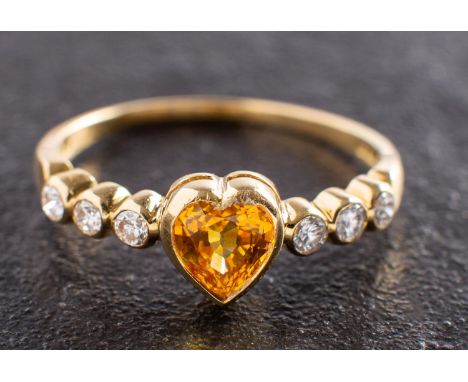 An 18ct gold, heart-shaped yellow sapphire and round, brilliant-cut diamond ring, estimated yellow sapphire weight ca. 0.90ct