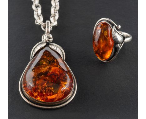 A pear-shaped amber pendant and ring, with applied foliate decoration, together with a belcher-link chain, length of pendant 