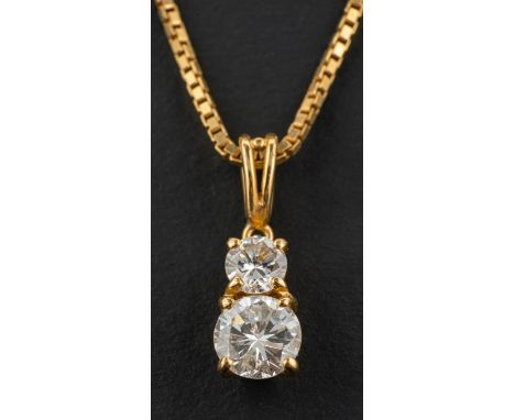 A round, brilliant-cut diamond two-stone pendant, weight of principal diamond ca. 0.60ct, G-H colour, fracture filled, weight