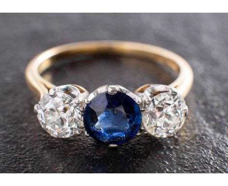 A sapphire and old-cut diamond, three-stone ring, estimated sapphire weight ca. 1ct, total estimated diamond weight ca. 1.35c