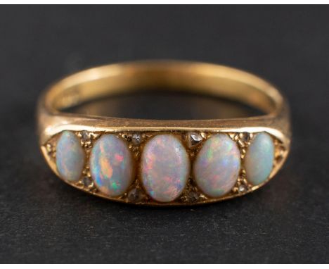 A cabochon-cut opal, half eternity ring with rose-cut diamond spacers, stamped '18CT', length of ring head ca. 2cm, ring size