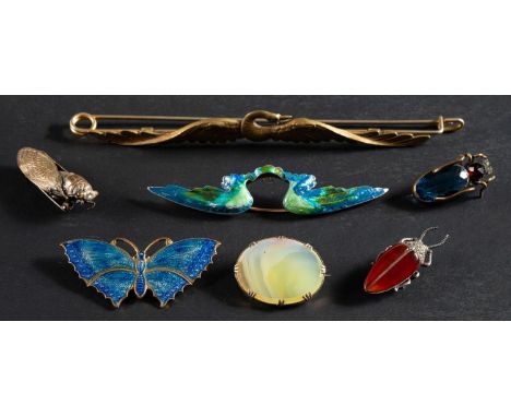 A collection of seven brooches, including, amongst others, a moth brooch, a pyrite and carnelian beetle brooch, a blue enamel