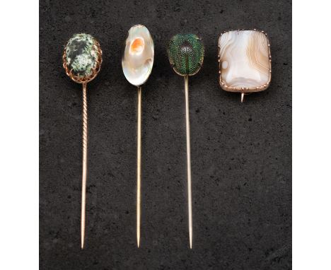 Three tiepins and a brooch, including mother-of-pearl and beetle tiepins, both stamped 'STERLING',  a ceramic marbled-effect 