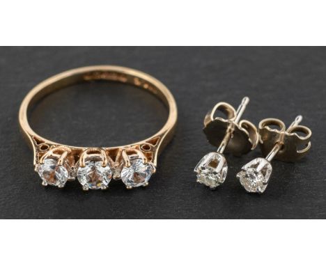 A 9ct gold, synthetic, white spinel, three-stone ring and a pair of round, brilliant-cut ear studs, total estimated diamond w