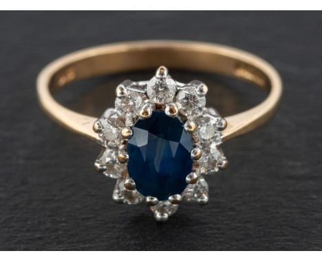 A 9ct gold, sapphire and round, brilliant-cut diamond cluster ring, estimated sapphire weight ca. 1.10cts, total estimated di