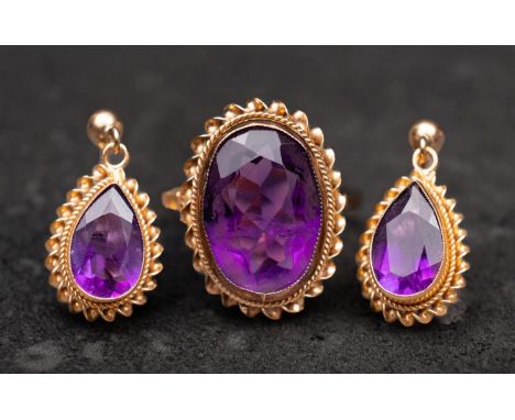 A 9ct gold, oval, mixed-cut amethyst ring and pair of drop earrings, with ropework surround, the earrings with post fittings,