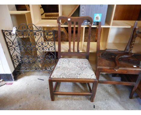 A wrought iron firescreen with scroll decoration, a Georgian mahogany framed dining chair with pierced centre splat, drop in 