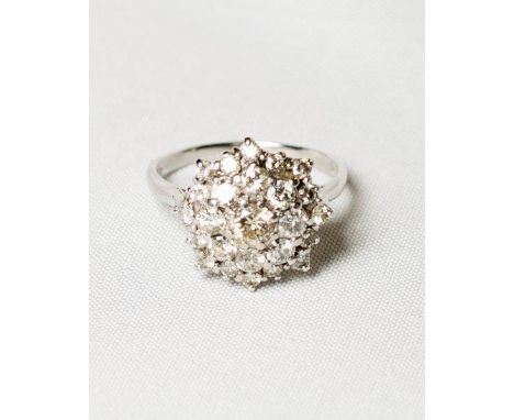 A lady's diamond set flower cluster ring on an 18ct. white gold shank