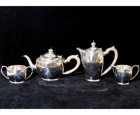 A silver four piece tea service with reeded rims comprising:- teapot, hot water jug, cream jug and double handled sucrier - L