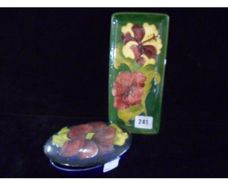 A Moorcroft pin tray, green decorated hibiscus and a Moorcroft oval trinket box, blue decorated anemone