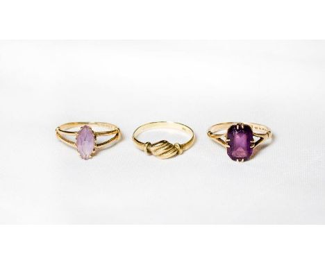 A lady's ring set amethyst coloured stone, on a 9ct. gold shank, a 9ct. gold ring and one other dress ring set amethyst colou