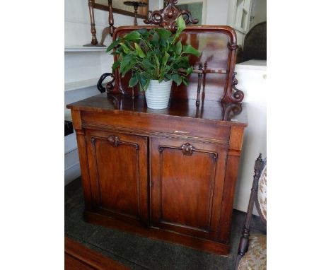 A Victorian mahogany chiffonier, the raised back with shaped pediment, fitted mirror and shelf, the base with wide frieze dra