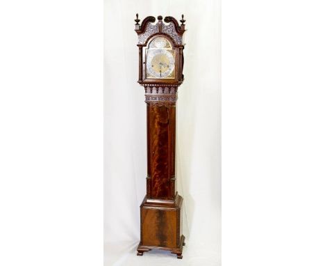 A reproduction granddaughter clock with brass dial, silvered chapter ring, striking spring driven movement, in a mahogany cas