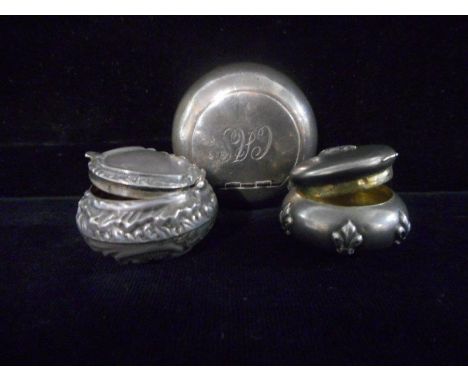 A circular silver snuff box - Birmingham 1979, a silver repousse decorated ditto and a small Continental silver pill box with