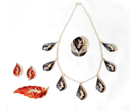 A Siam silver necklace with Niello work decoration, a similar brooch and a pair of Siam silver and red enamel earrings and ma