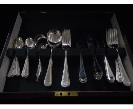 A canteen of silver plated flatware with beaded handles