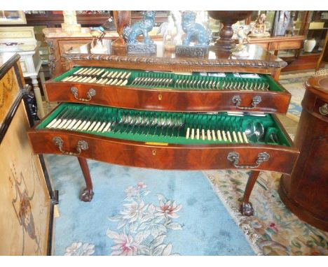 A mahogany canteen table with serpentine shaped front, rope carved edge, fitted two drawers, on cabriole legs with claw and b
