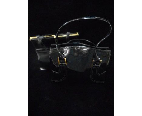 A vintage black leather hand back with gilt metal fittings and a black patent handbag with gilt metal fittings