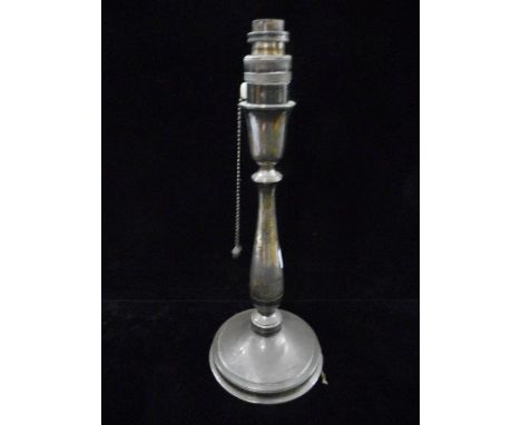 A silver candlestick on circular base converted to a tablelamp, a silver plated egg boiler, four cups and spoons, on stand an