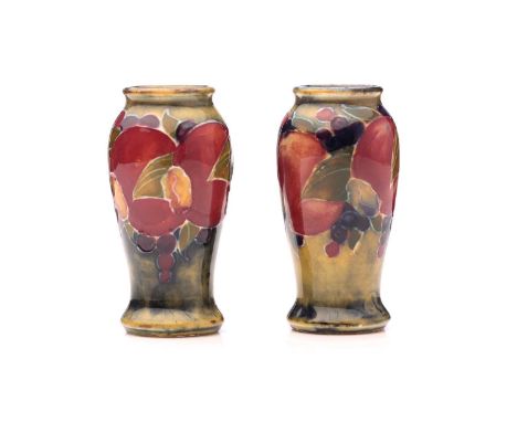 A pair of William Moorcroft miniature 'Pomegranate' baluster vases, both signed in green W M, one impressed number 'M52', 6cm