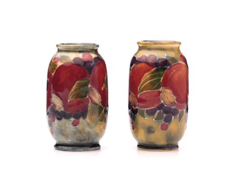A pair of William Moorcroft miniature 'Pomegranate' on ochre ground vases, signed W M, circa 1910, height 5.5cmQty: 2Good ord