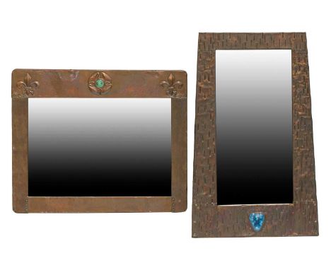 An Arts &amp; Crafts beaten copper rectangular wall mirror decorated with raised fleur-de-lis motif and stylized rose with ap