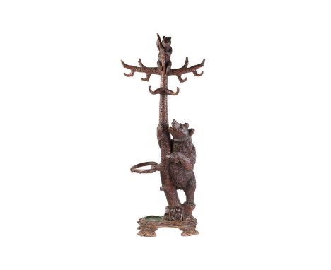 A large late 19th-century carved wood Black Forest Bear hall stand; modelled as a bear cub seated atop a tree trunk observed 