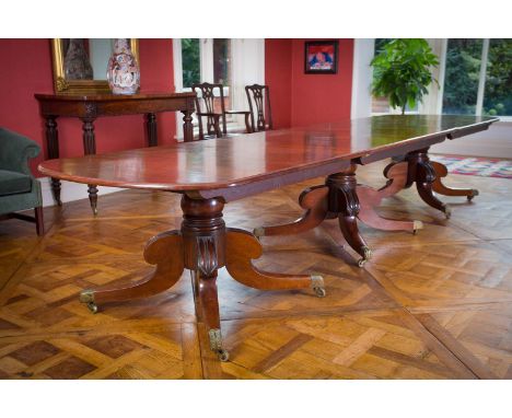 A MAHOGANY THREE PILLAR DINING TABLE, 19th CENTURY, with rounded ends, on three pods with bulbous turned supports on hipped q