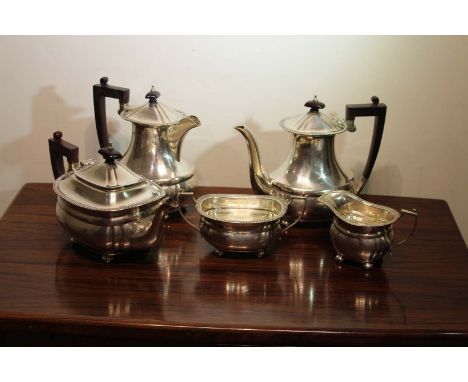 A Five Piece Sliver Tea and Coffee service , of oval form , Birmingham , With gadroomed rim , on bun feet .