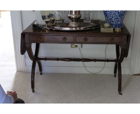 A MAHOGANY SOFA TABLE, in Regency style with two frieze drawers on  'X' framed supports joined by a baluster turned stretcher