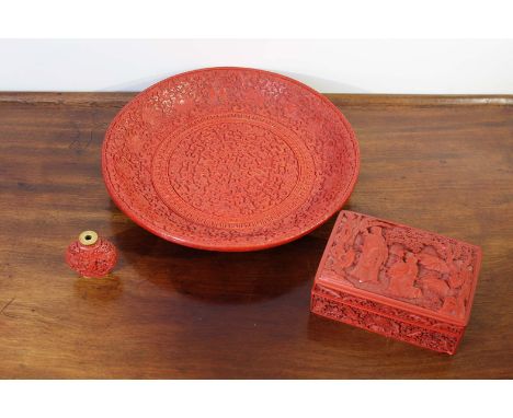 A  Chinese red lacquered cinnabar shallow dish decorated in a typical palette, signed to the underside, 29cms diameter; and a