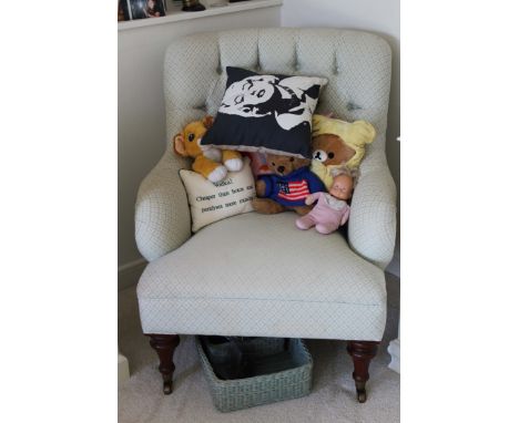 A VICTORIAN STYLE COLEFAX AND FOWLER UPHOLSTERED BUTTON BACK ARMCHAIR, on baluster turned legs and brass castors.

