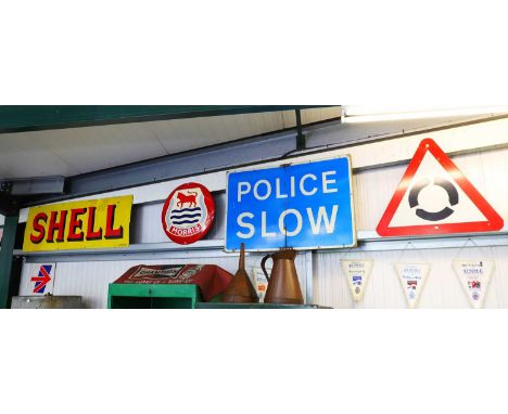 A Shell enamel advertising sign,137 wide46cm high, a reproduction Morris sign,a 'Police Slow' sign, anda roundabout warning s