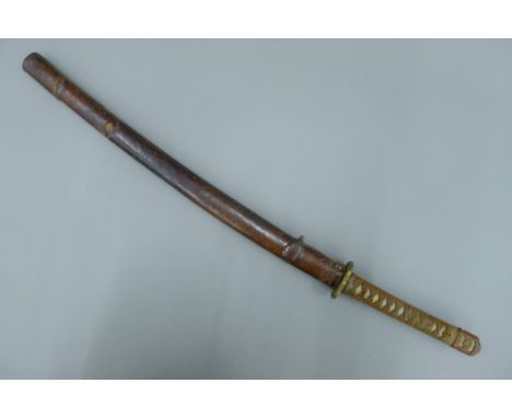 An early 20th century Japanese Katana sword, in leather scabbard. 98 cm long overall.