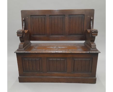 A carved oak monk's bench. 107 cm wide.