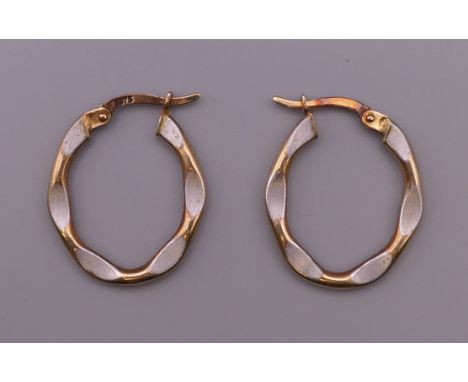 A pair of 9 ct gold and enamel earrings. 2 cm high. 1.2 grammes total weight.