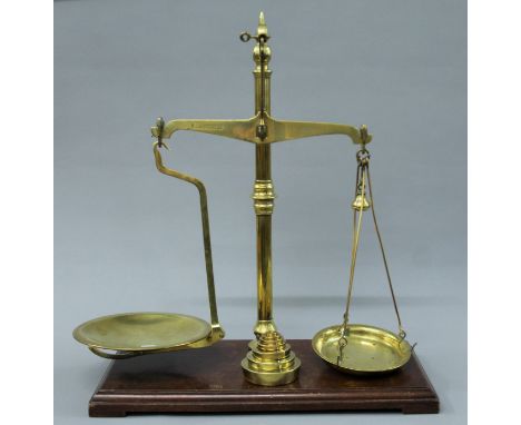 A 19th century set of brass scales by Avery and a set of brass weights. 50.5 cm wide.