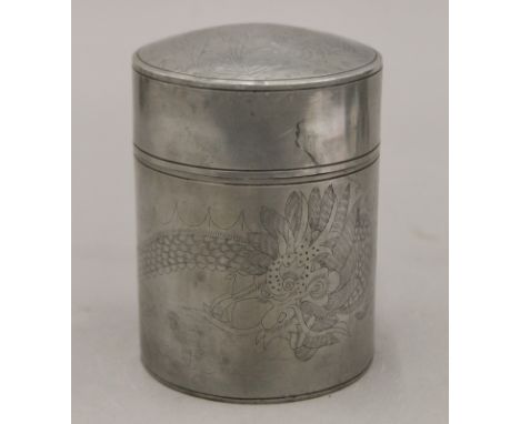 A Chinese pewter tea caddy chased with dragon and birds. 13.5 cm high.